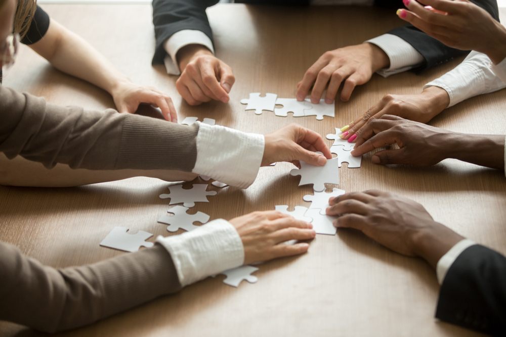 team putting a custom puzzle together